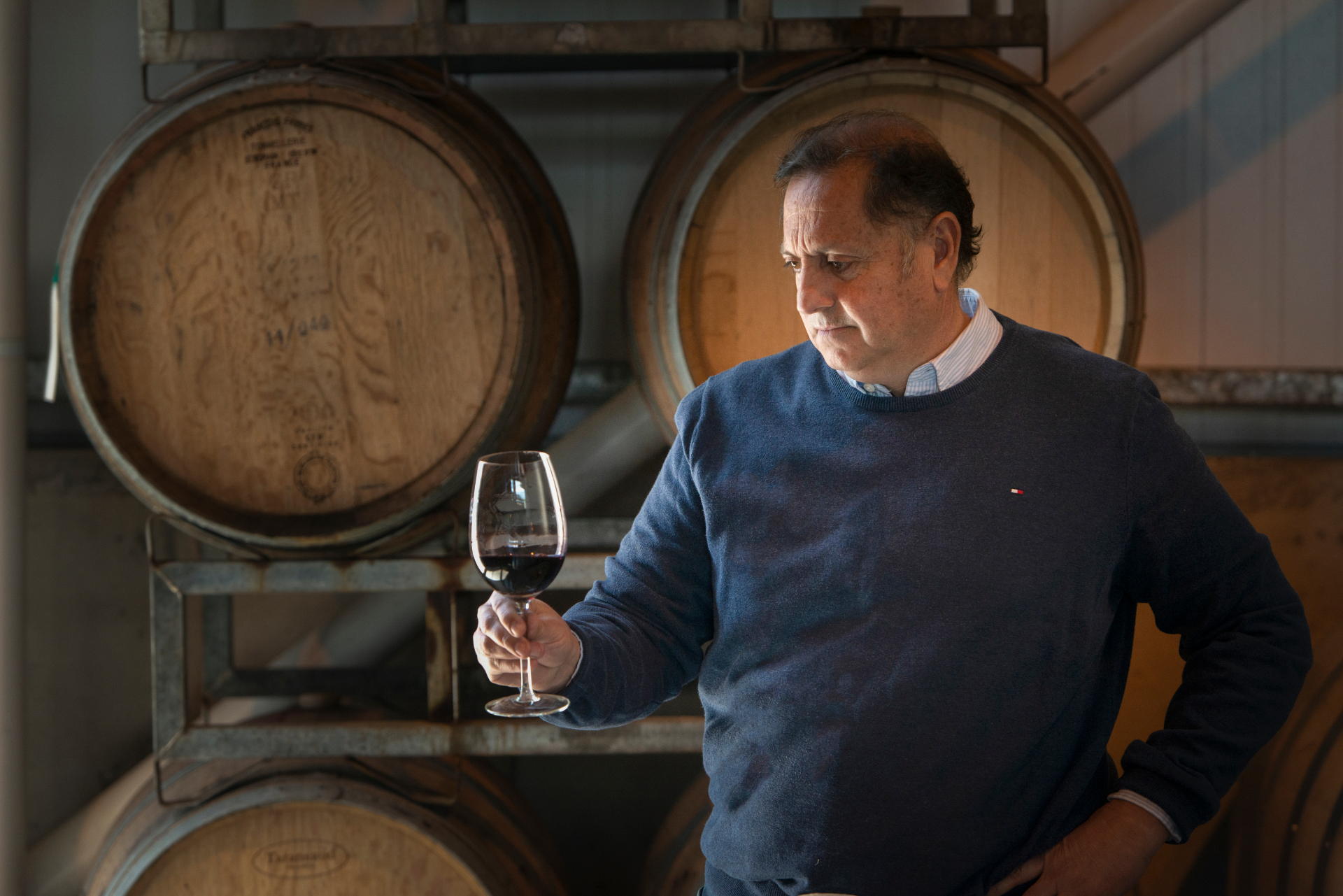 Winemaker in cellar with wine glass